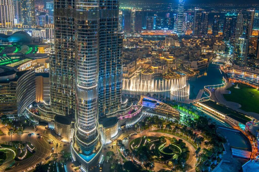 an aerial view of a city at night at FIRST CLASS 2BR with full BURJ KHALIFA and FOUNTAIN VIEW in Dubai