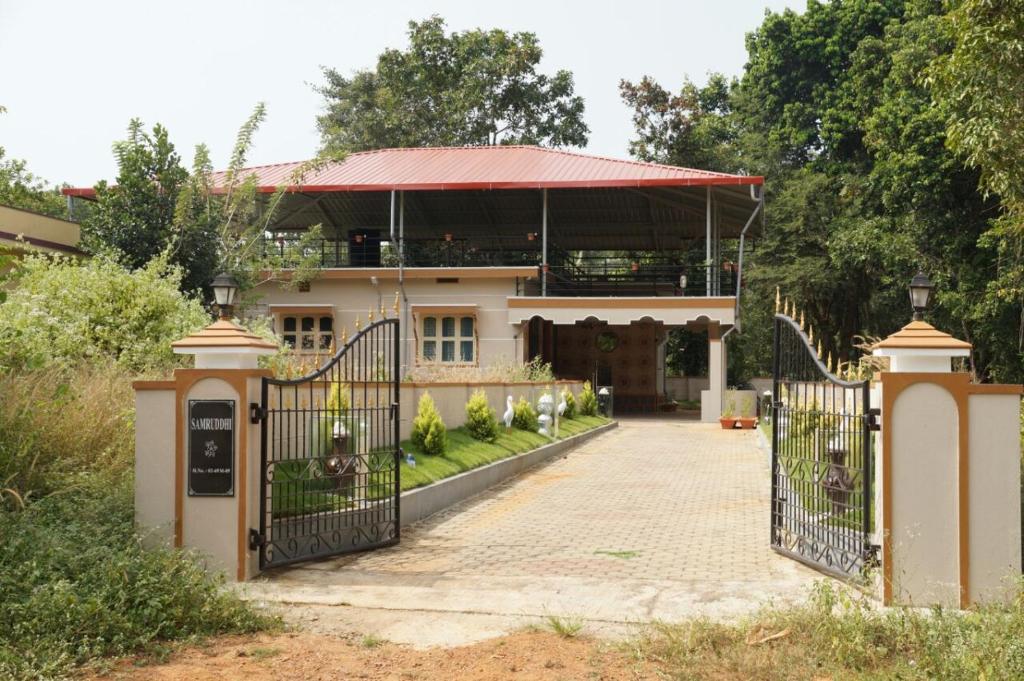 a house with a gate in front of it at Reunion Villa Abode in Udupi