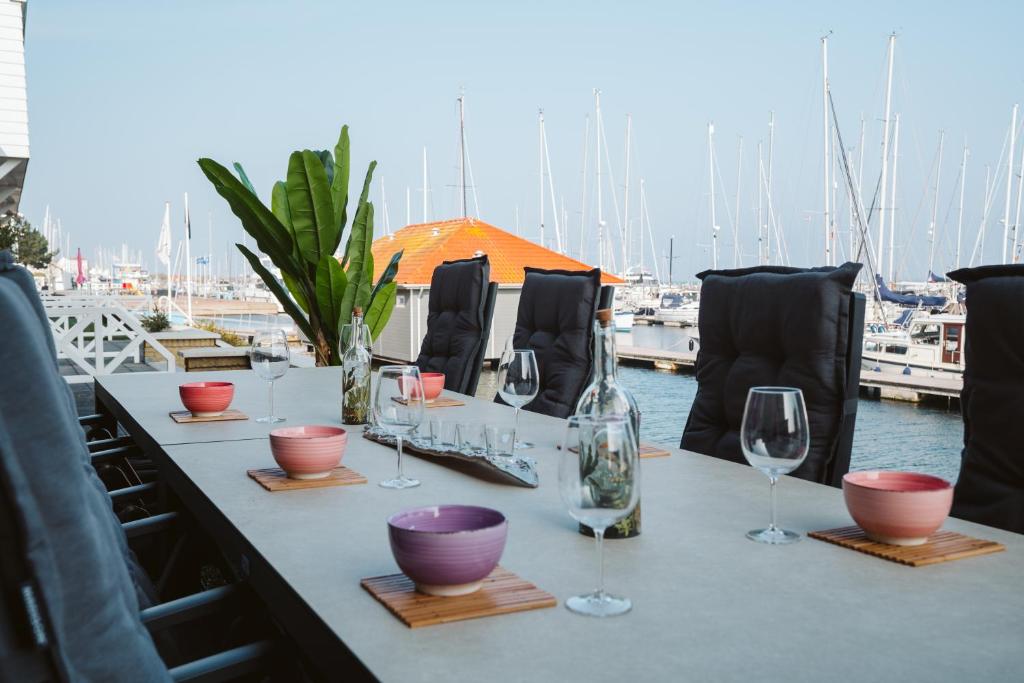 einen Tisch mit Weingläsern auf einem Tisch mit Yachthafen in der Unterkunft Appartement in Zeeland - Kabbelaarsbank 2D - Port Marina Zélande - Ouddorp in Ouddorp