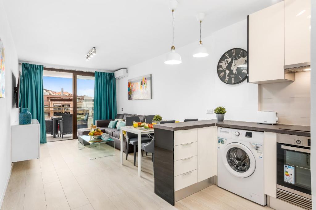 a kitchen and living room with a washer and dryer at MODERN APARTMENTS LOS CRISTIANOS CENTER in Los Cristianos