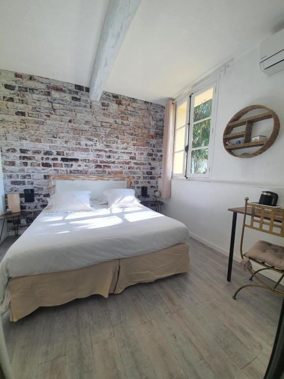 Postel nebo postele na pokoji v ubytování Hôtel Auberge Provençale