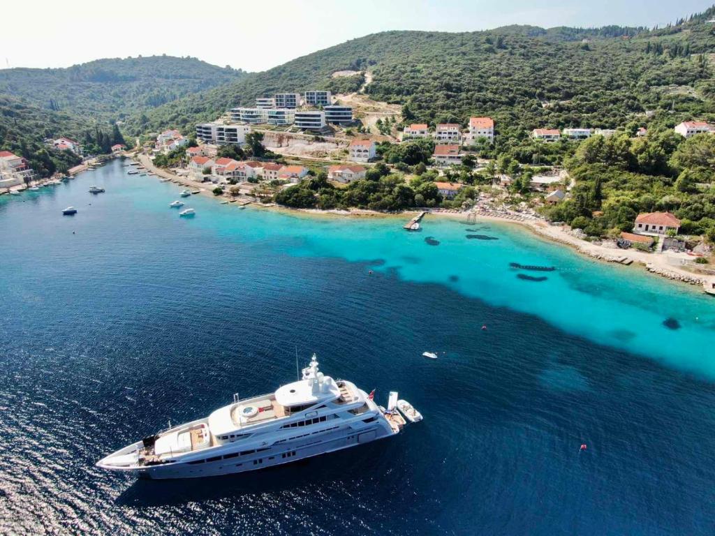 a yacht in the water next to a beach at Korcula Hill in Korčula