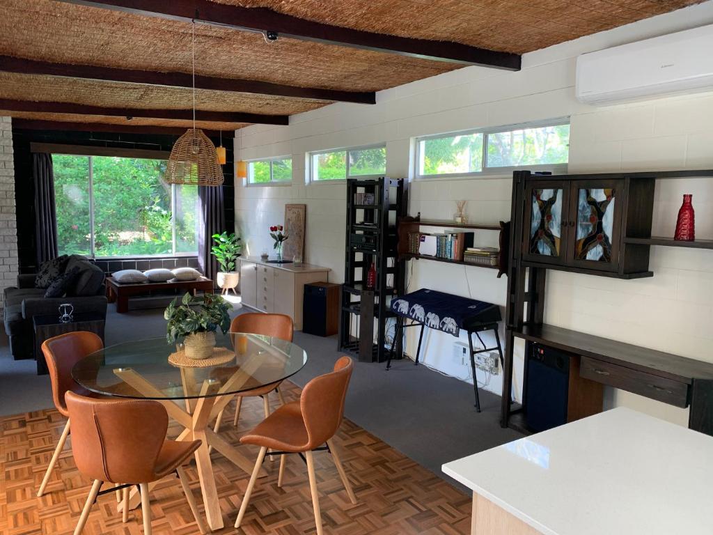 a living room with a glass table and chairs at Ponderosa in Sapphire Beach