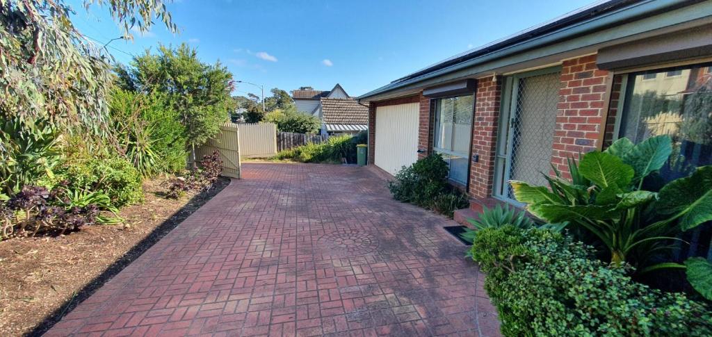 a brick walkway in front of a house at City Edge Lower Plenty in Lower Plenty