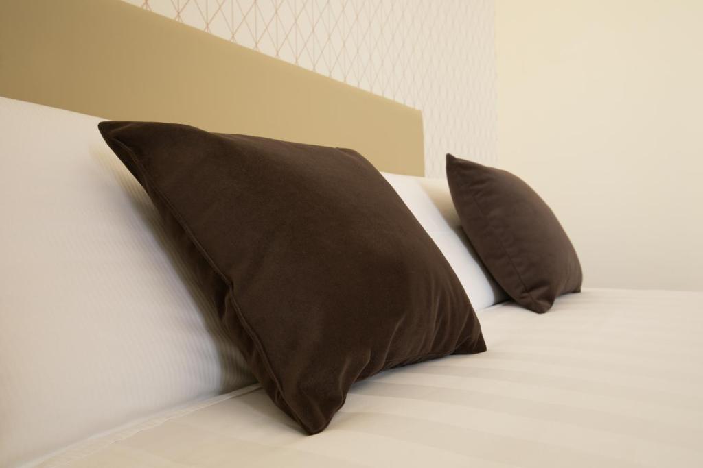 Postel nebo postele na pokoji v ubytování Hotel Enzo
