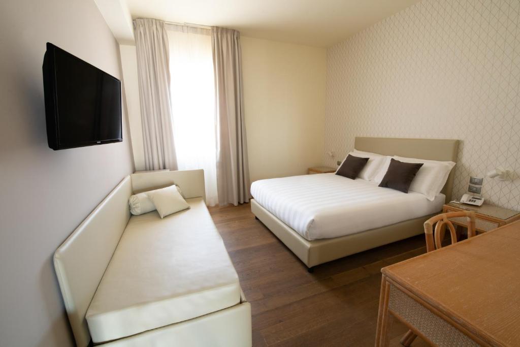 Postel nebo postele na pokoji v ubytování Hotel Enzo