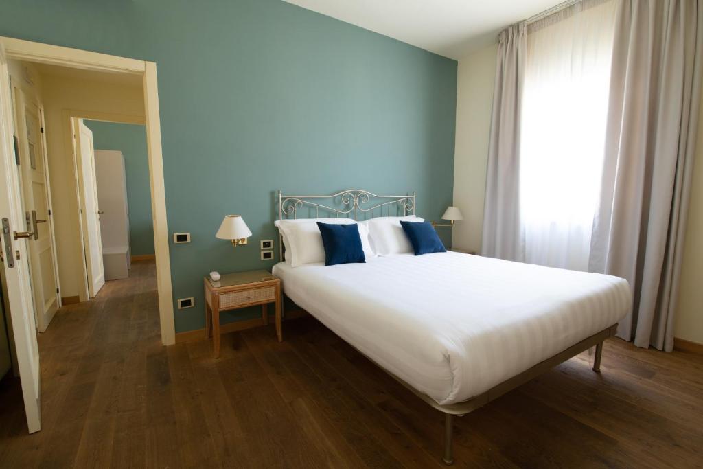Postel nebo postele na pokoji v ubytování Hotel Enzo
