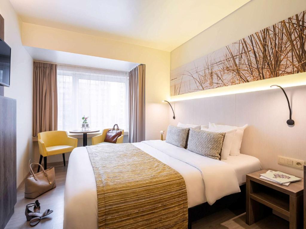 Een bed of bedden in een kamer bij Mercure Oostende