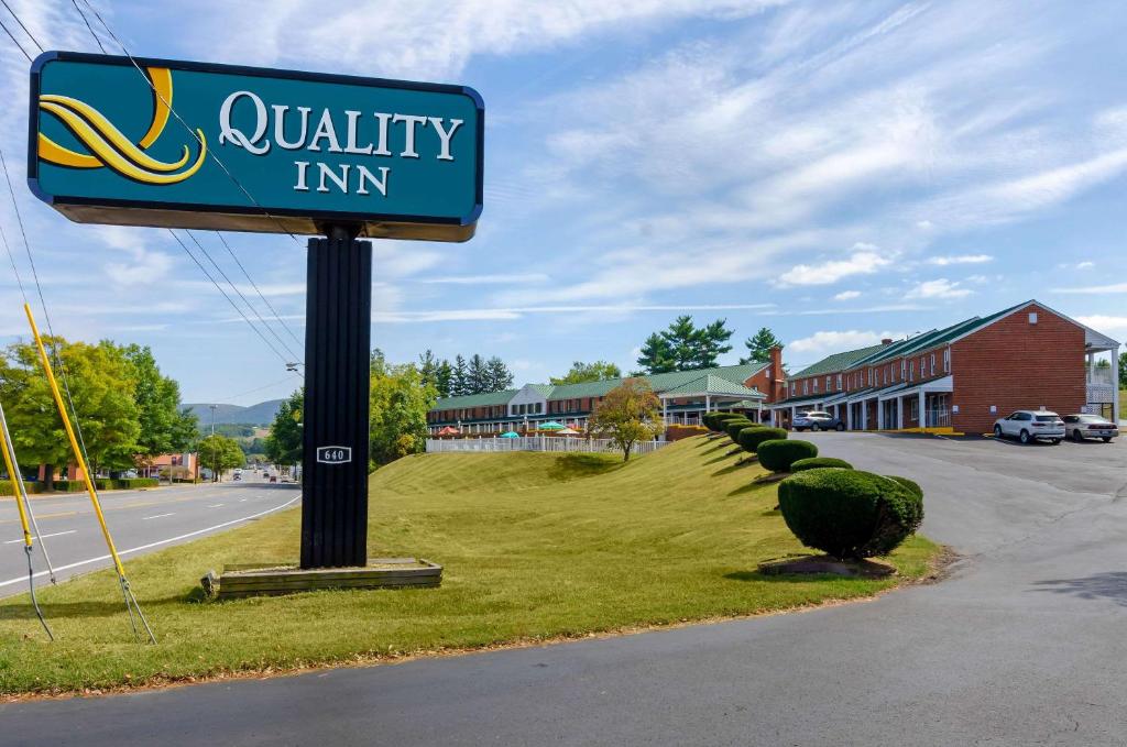 a sign for a quality inn on the side of a road at Quality Inn Waynesboro - Skyline Drive in Waynesboro