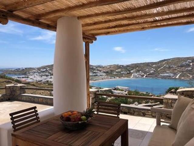 a table with a bowl of fruit on a balcony at Casa Elena in Aggelika