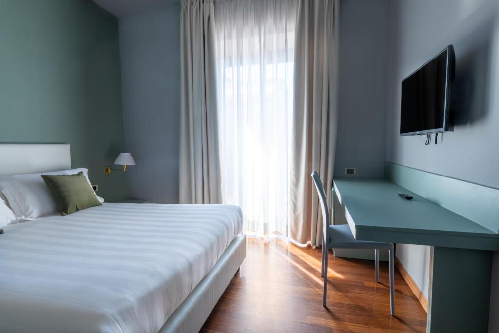 Postel nebo postele na pokoji v ubytování Hotel Enzo