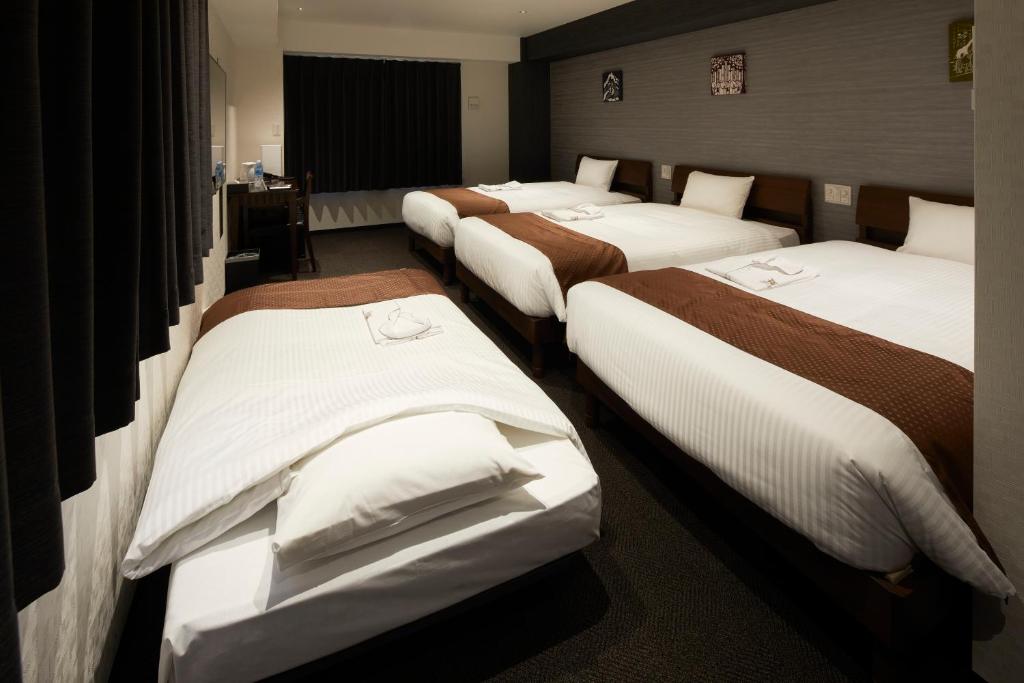 Postel nebo postele na pokoji v ubytování HOTEL BRILLER Kyoto Station South