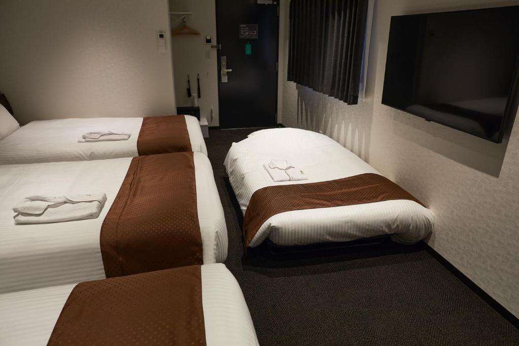 Postel nebo postele na pokoji v ubytování HOTEL BRILLER Kyoto Station South