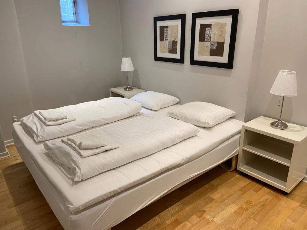 a white bed with two pillows on top of it at Gothersgade in Copenhagen