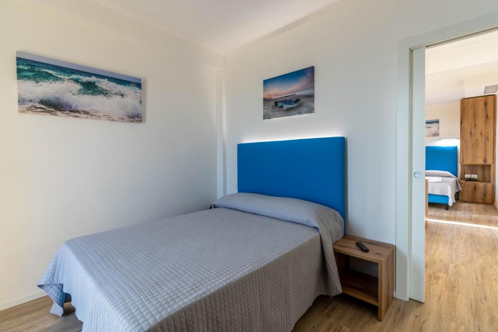 Postel nebo postele na pokoji v ubytování Hotel Mondial