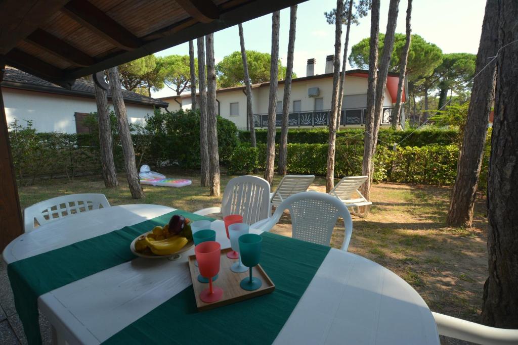 a table with a plate of fruit and drinks on it at Villa in Lignano Riviera comfortable in Lignano Sabbiadoro
