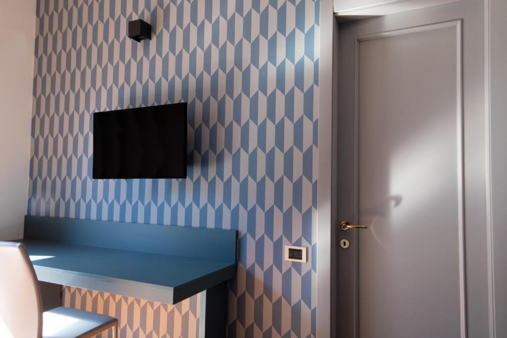 TV a/nebo společenská místnost v ubytování Hotel Enzo
