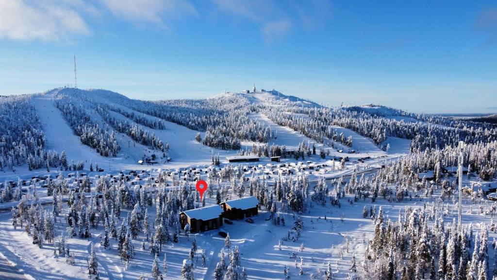 a snow covered mountain with trees and a stop sign at Holiday homes Ruka in Ruka
