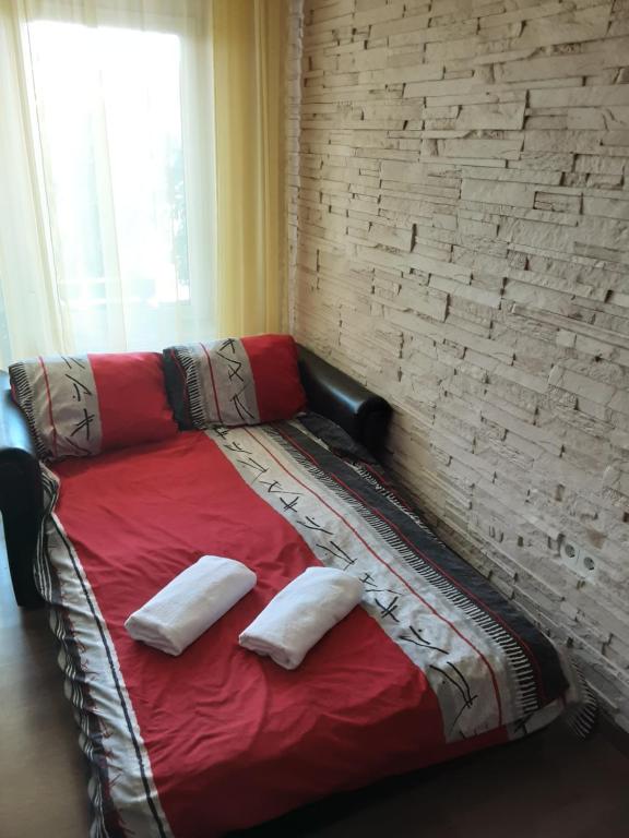 a couch with two pillows on it in a room at MELÁNIA in Vonyarcvashegy