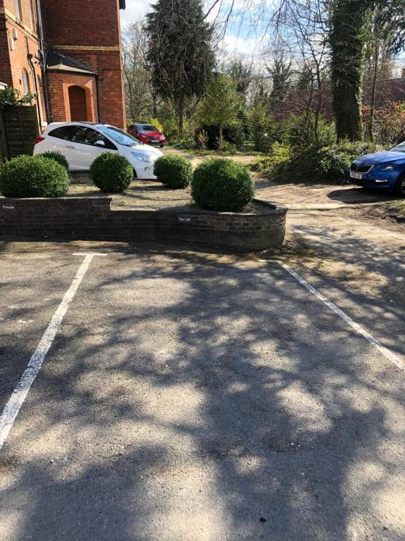 a parking lot with a car parked in a driveway at Time is now! Beautiful Apartment in York in York