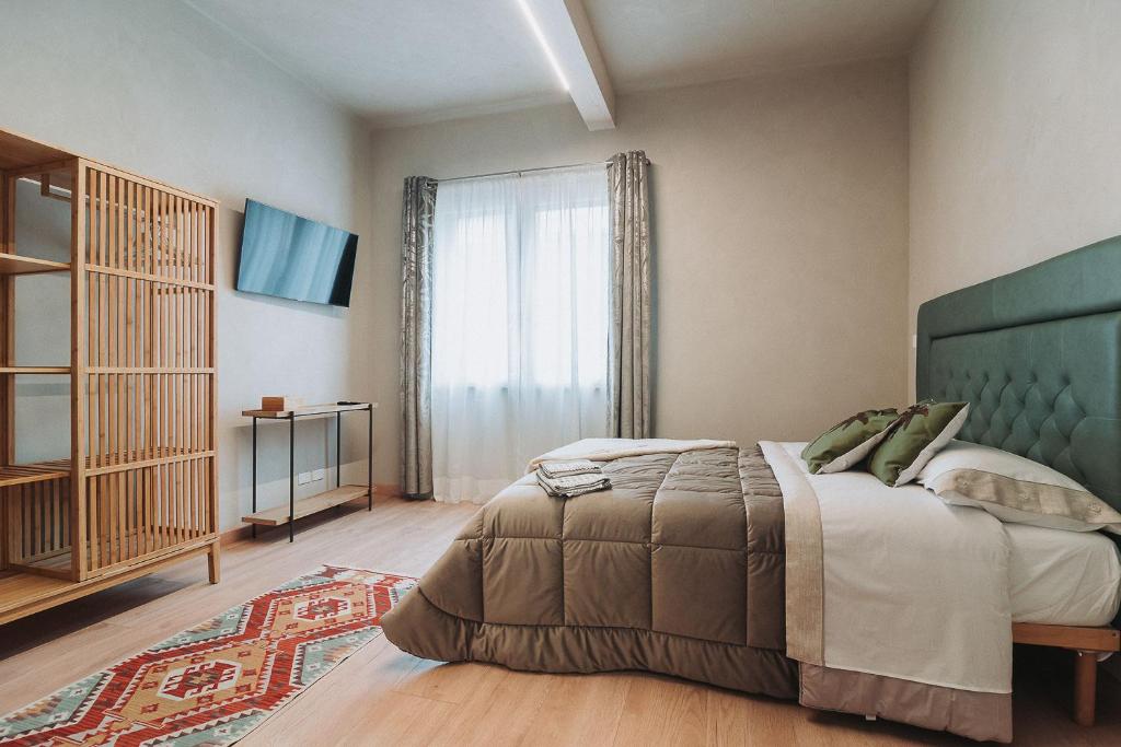 a bedroom with a bed and a large window at B&B CAVOUR 117 in Porto SantʼElpidio