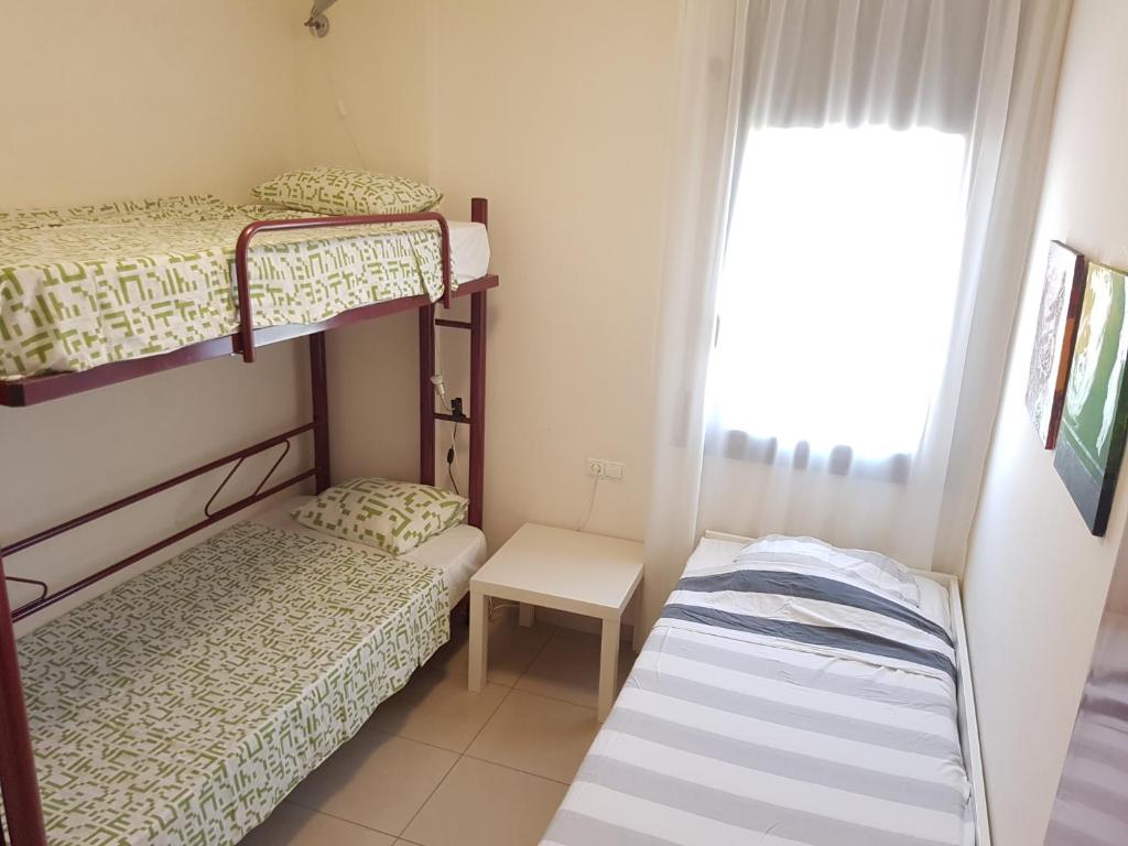 A bed or beds in a room at Beautiful apartment 75m2 with view at the beach, pool, parking