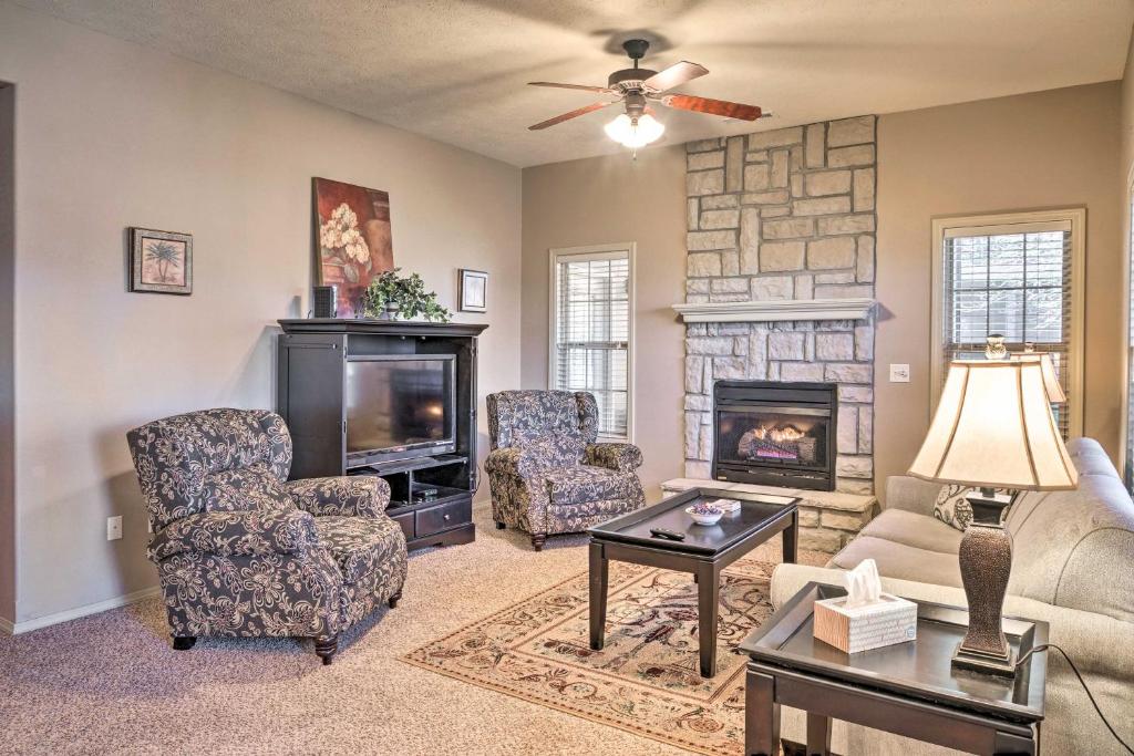 a living room with a couch and chairs and a fireplace at Stonebridge Resort Condo Near Silver Dollar City! in Branson West