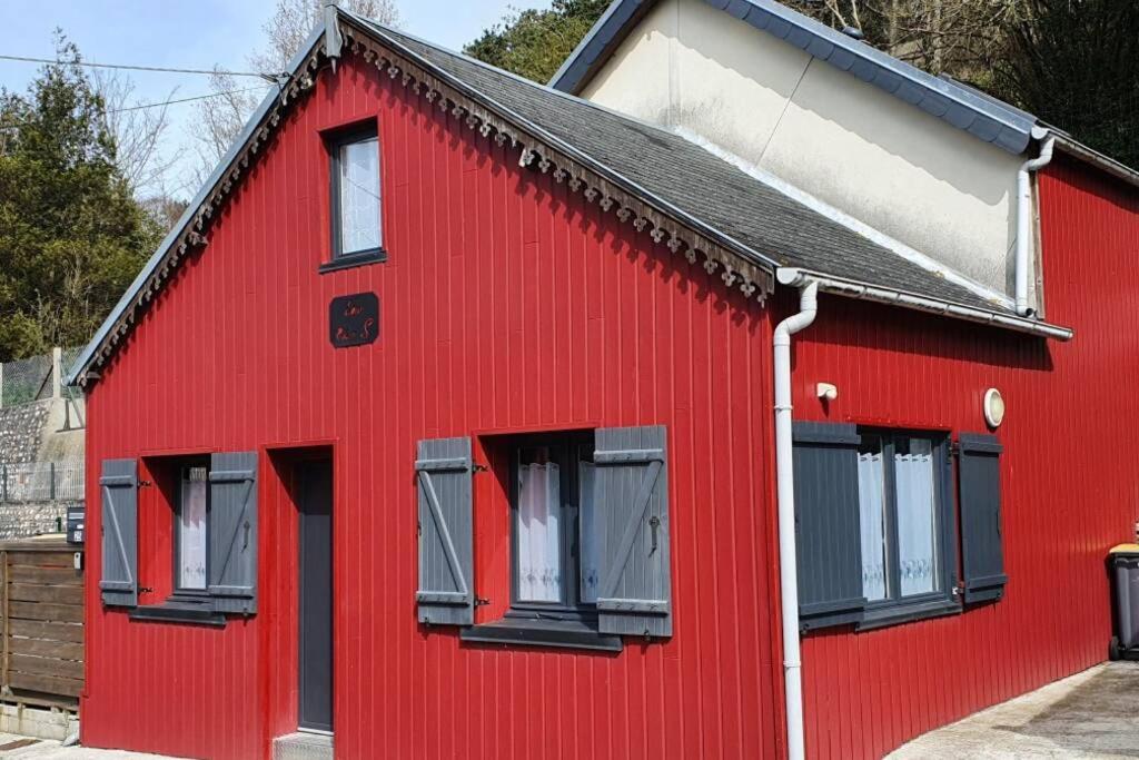 a red house with black windows on a street at Chalet Low Rider S in Fécamp