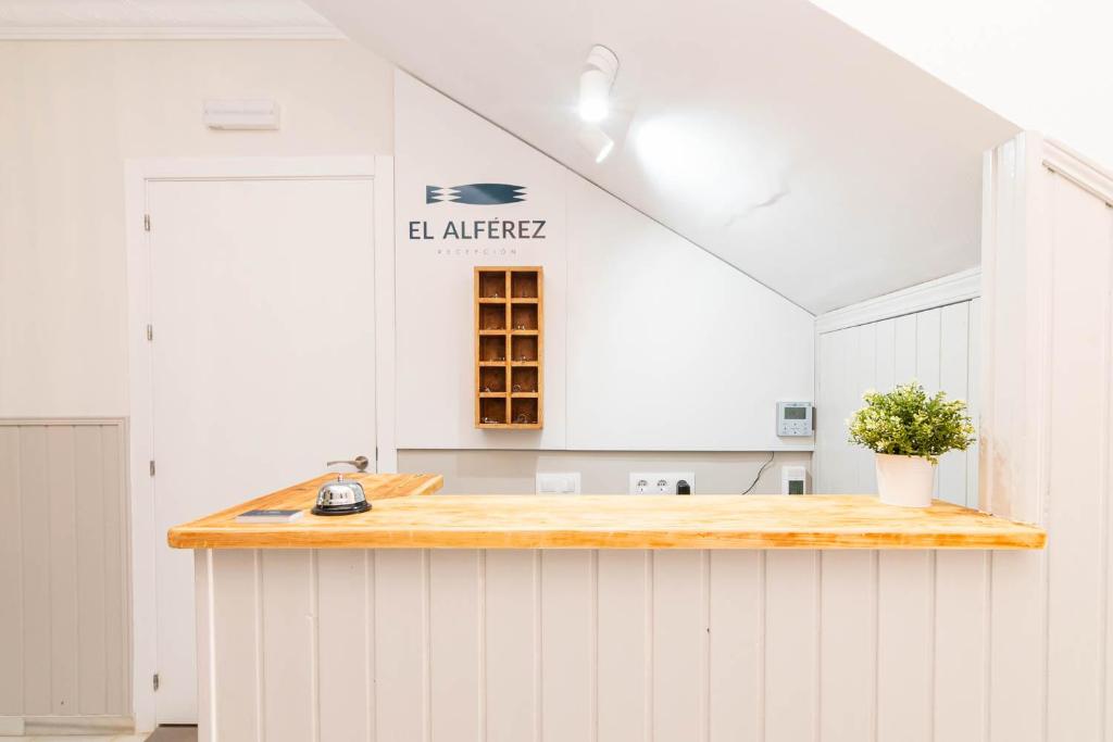 a kitchen with a white counter top and white cabinets at Hostal El Alférez in El Palmar