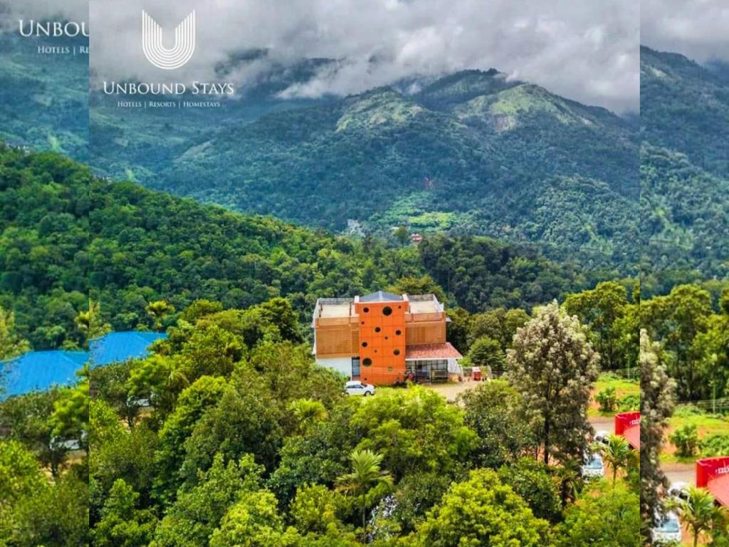an aerial view of a building in the middle of a mountain at Palmtree Leaf, Munnar in Munnar