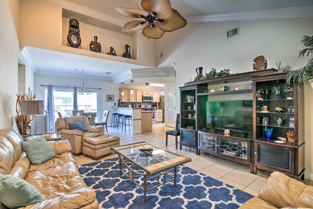 a living room with a large television and a living room at South Padre Island Condo with Pool Access and Balcony! in South Padre Island