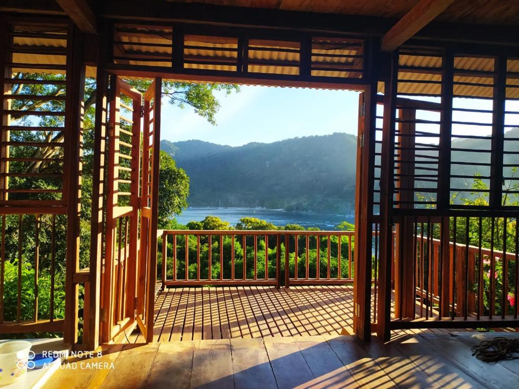 a screened in porch with a view of a lake at Cabana El Caney in Sapzurro