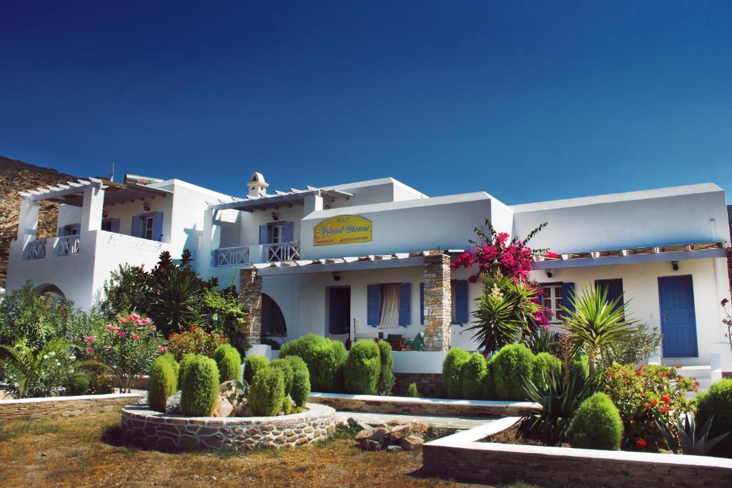a white building with plants in front of it at Island House Mare in Mylopotas