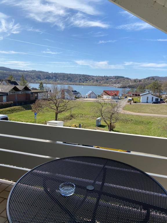 a table on a balcony with a view of the water at Fewo Seeresidenz auf Scheid in Waldeck