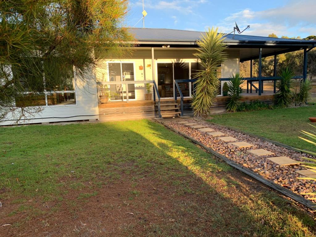 a house with a pathway leading to the front yard at Kangaroo Island Cabins in Kingscote