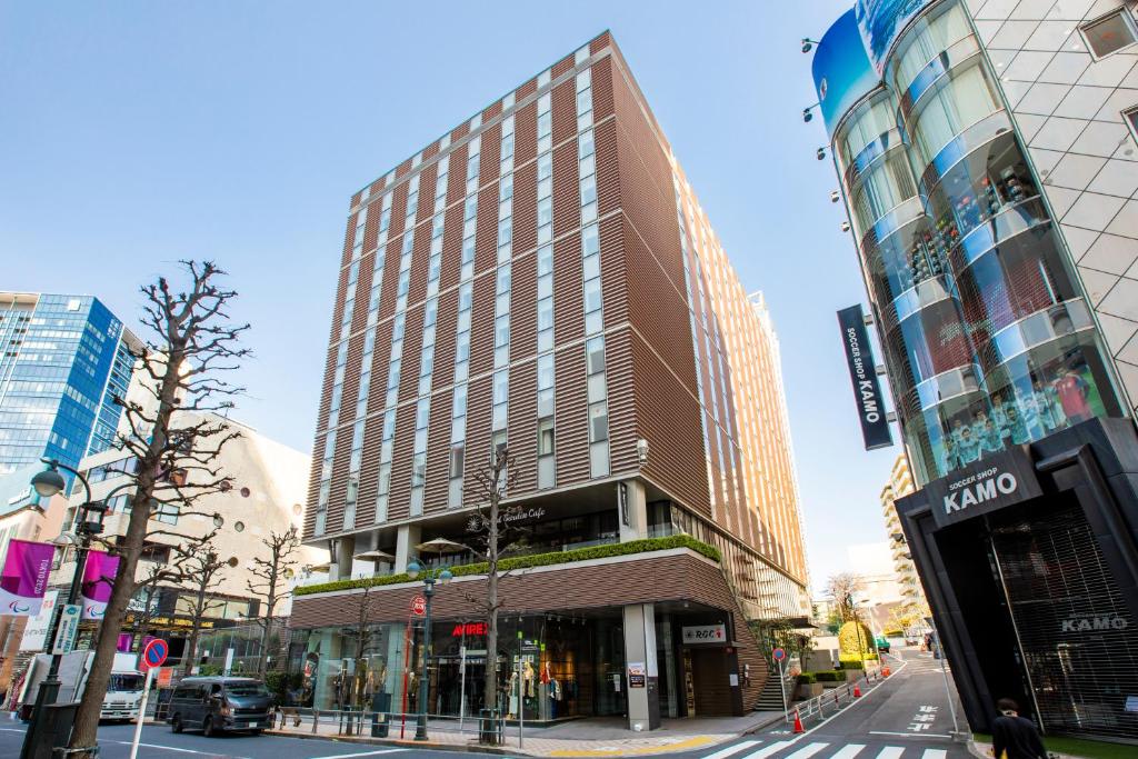 a tall building on the corner of a city street at Hotel Wing International Premium Shibuya in Tokyo