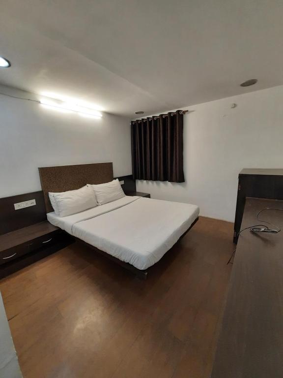Postel nebo postele na pokoji v ubytování Hotel Grand Suites