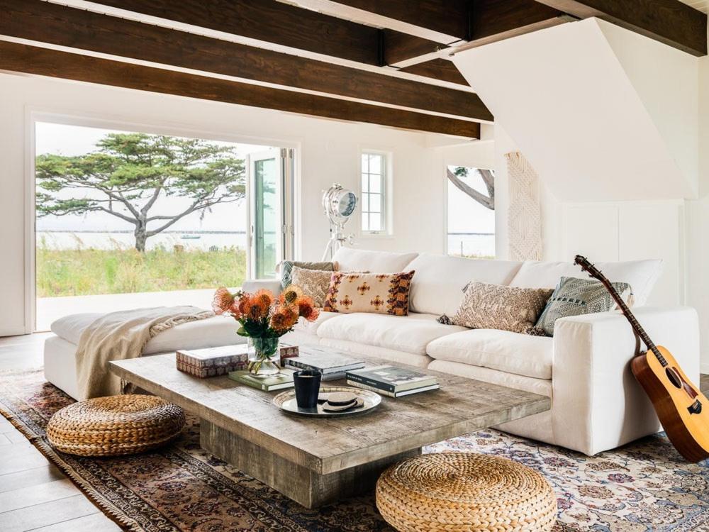 a living room with a white couch and a guitar at A little piece of heaven... in Half Moon Bay