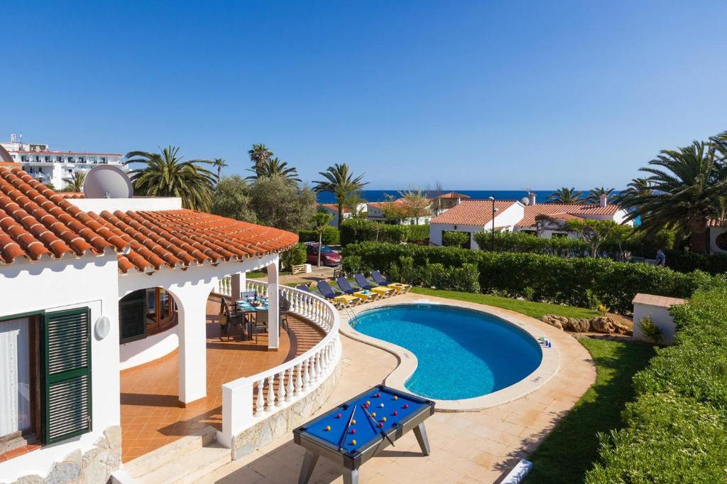 a villa with a swimming pool and a house at Villa Lavanda by Villa Plus in Santo Tomás
