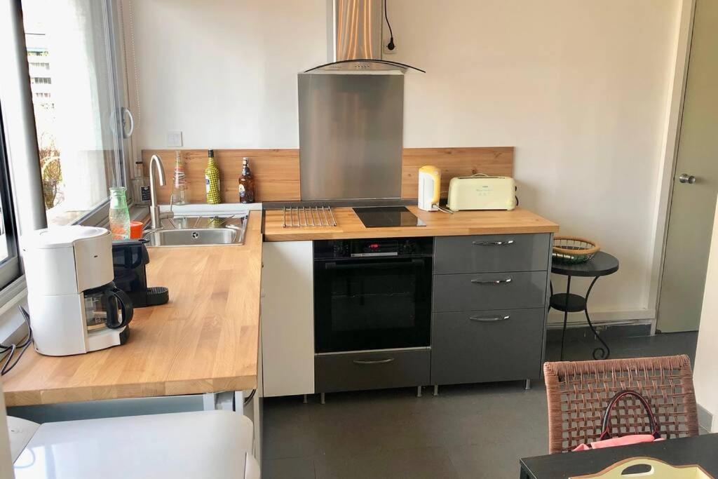 a kitchen with a sink and a stove top oven at Meublé Prado Vélodrome in Marseille