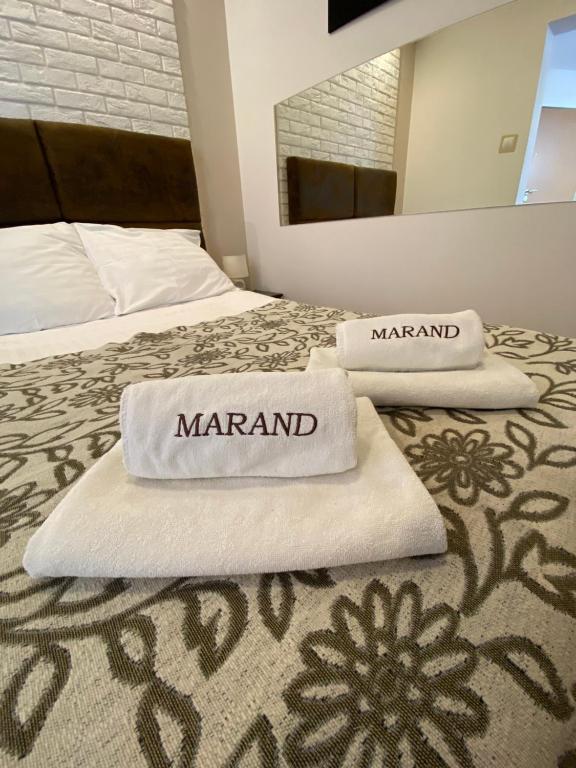 two white towels on two beds with a mirror at Hotel Marand in Rzeszów