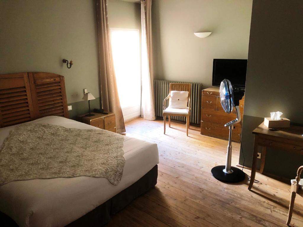 Postel nebo postele na pokoji v ubytování Le Couvent