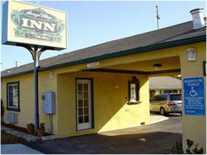 a building with a sign in front of it at Arroyo Village Inn in Arroyo Grande