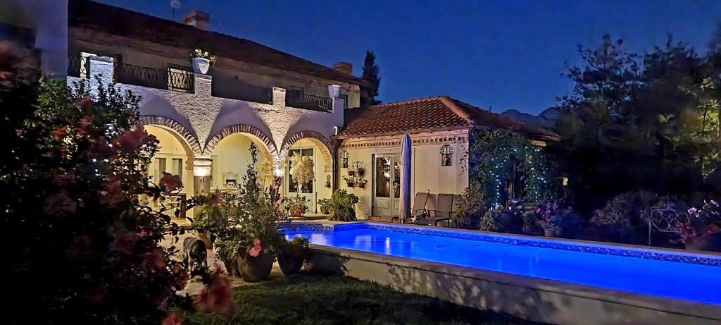 a house with a swimming pool at night at Sandmartins Private Secure Villa in Simondium