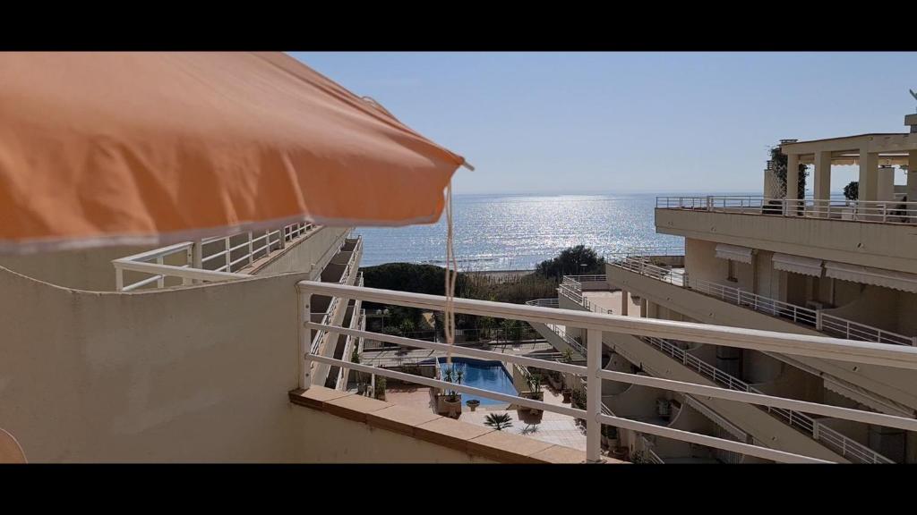 a balcony of a building with a view of the ocean at Atico con vistas al mar Primera línea Cala Montero - ALBERT VILLAS Alcossebre in Alcossebre