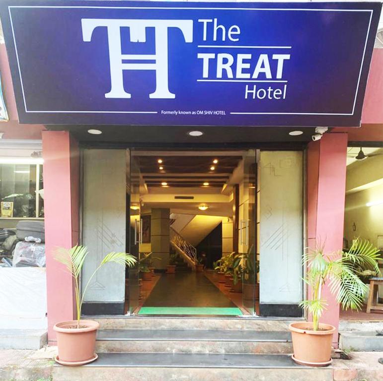a hotel with a sign that reads the treat hotel at The Treat Hotel in Madgaon