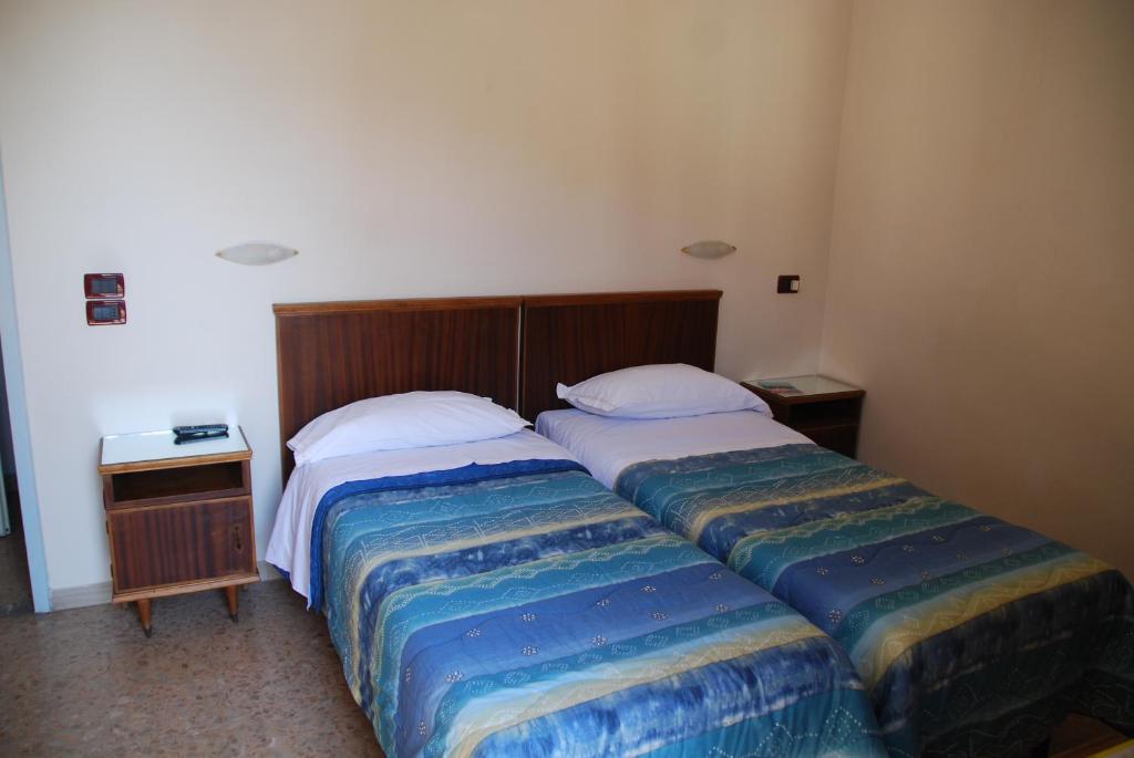 Postel nebo postele na pokoji v ubytování Hotel Conchiglia