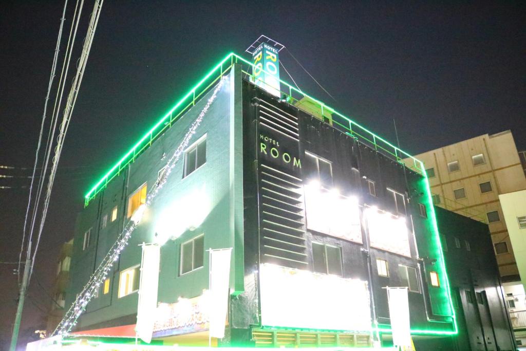 a building with green lights on the side of it at Hotel Room in Miyazaki