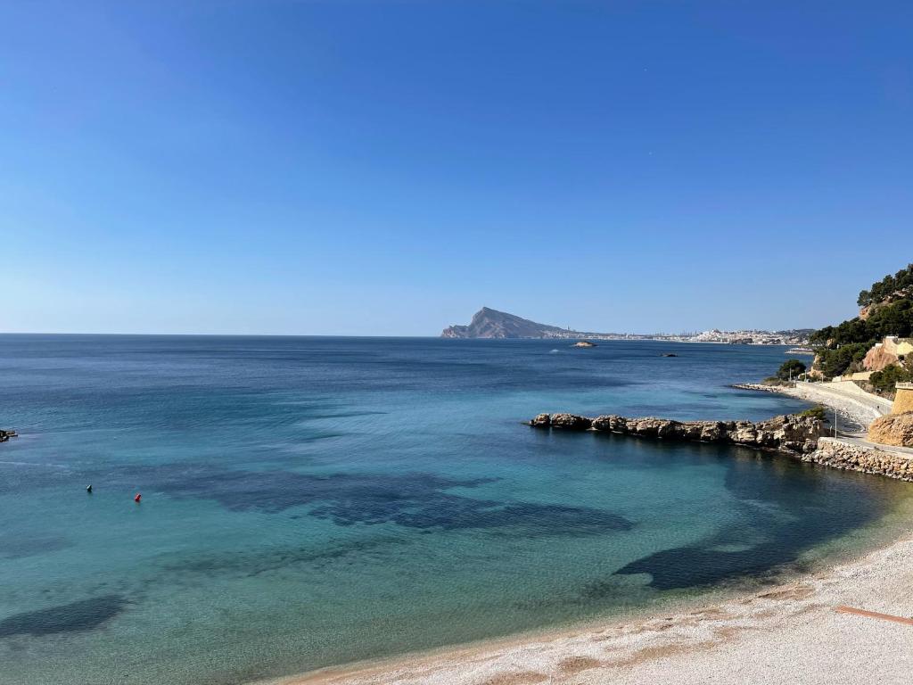 a beach with people swimming in the water at Palo Mayor 21 in Altea