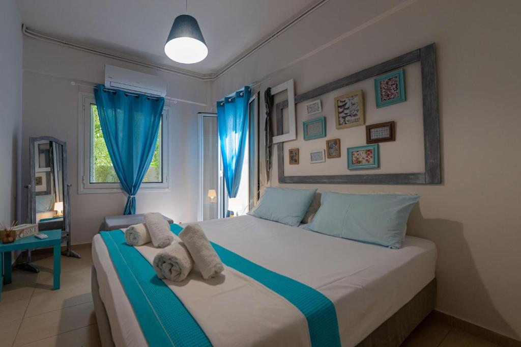 a bedroom with a bed with towels on it at Sea Villa in Akrogiali